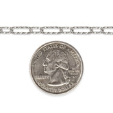 Diamond-cut sterling silver chain next to a quarter dollar coin on a white background